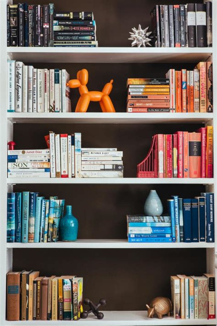 A bookshelf stacked with many books.