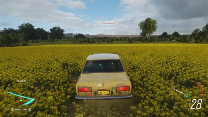 Screenshot of Forza Horizon 4 showing a sign balanced on top of a church, as seen from the perspective of a driver in the car